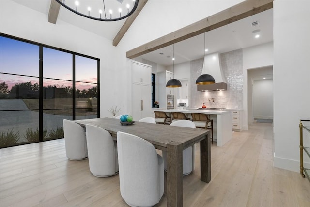 5805 Twin Peaks Trce, Austin, TX 78738 - dining area with beamed ceiling, light wood-style floors, and high vaulted ceiling