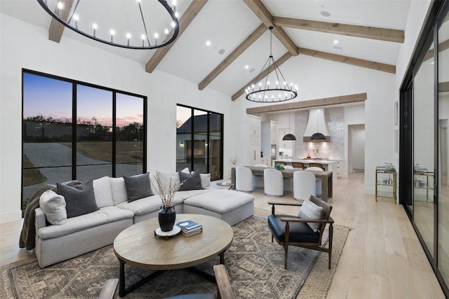 5805 Twin Peaks Trce, Austin, TX 78738 - living area featuring a chandelier, beam ceiling, light wood-style flooring, and high vaulted ceiling