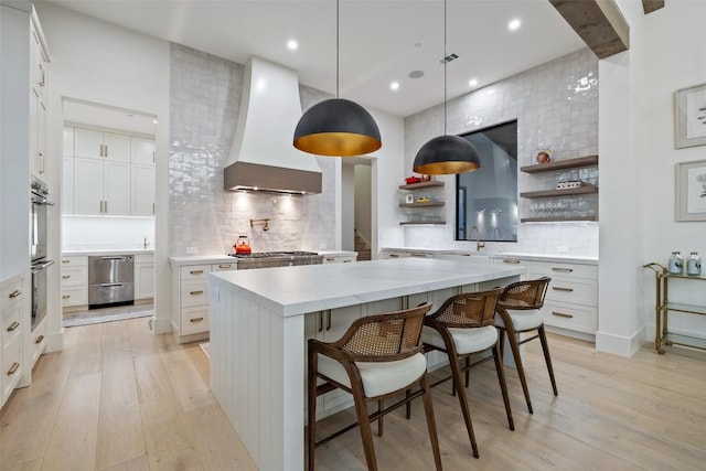 5805 Twin Peaks Trce, Austin, TX 78738 - kitchen with custom exhaust hood, open shelves, light wood finished floors, tasteful backsplash, and recessed lighting