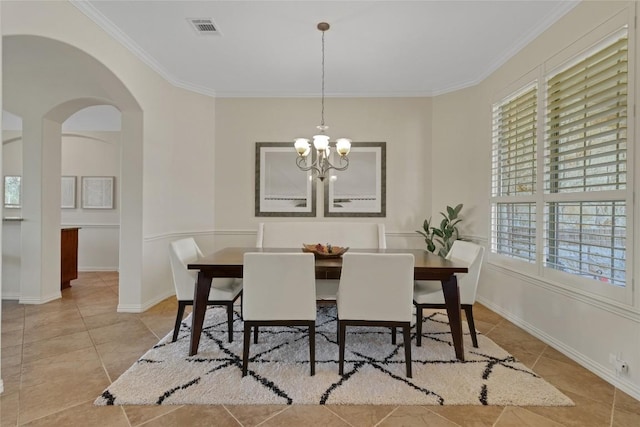 4004 Buckhaven Cv, Cedar Park, TX 78613 - tiled dining space featuring crown molding, arched walkways, a chandelier, and baseboards