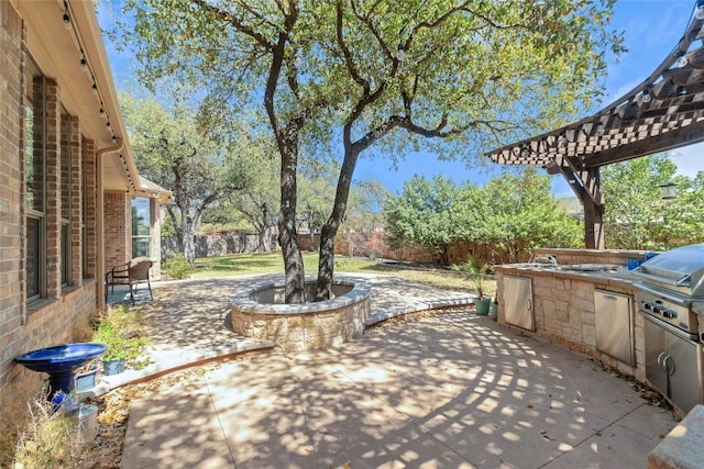 view of patio with area for grilling, a fenced backyard, and a pergola