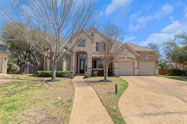 french country inspired facade featuring stone siding, concrete driveway, an attached garage, and brick siding