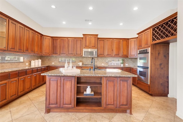 4004 Buckhaven Cv, Cedar Park, TX 78613 - kitchen with stainless steel appliances, a sink, decorative backsplash, brown cabinetry, and recessed lighting