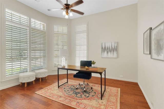 home office featuring ceiling fan, wood finished floors, and baseboards