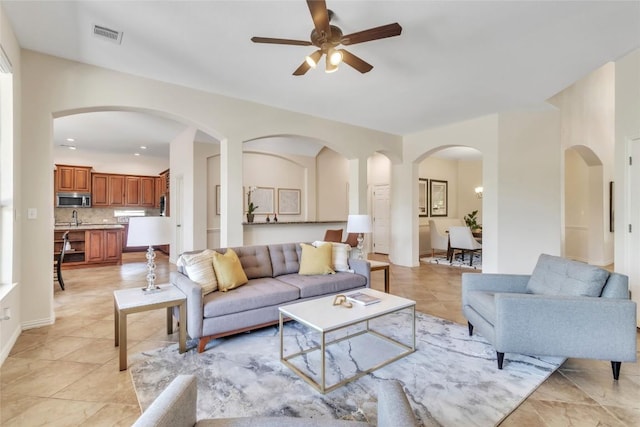 4004 Buckhaven Cv, Cedar Park, TX 78613 - living room featuring a ceiling fan, light tile patterned flooring, and arched walkways