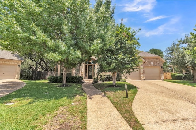 4004 Buckhaven Cv, Cedar Park, TX 78613 - view of property hidden behind natural elements featuring concrete driveway, brick siding, and an attached garage