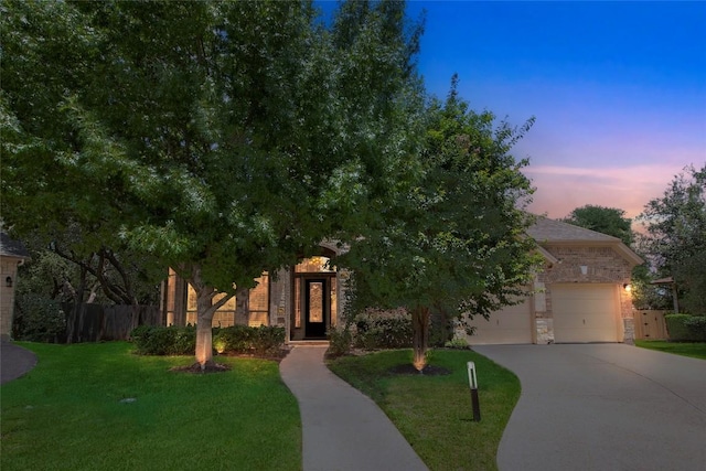 4004 Buckhaven Cv, Cedar Park, TX 78613 - obstructed view of property with driveway, stone siding, and an attached garage