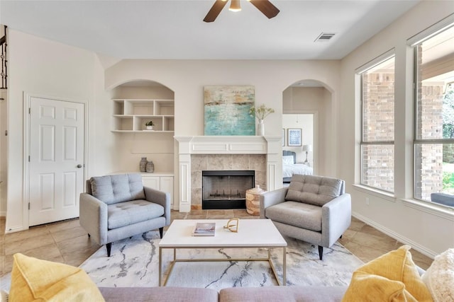4004 Buckhaven Cv, Cedar Park, TX 78613 - living room featuring light tile patterned flooring, ceiling fan, a fireplace, and baseboards