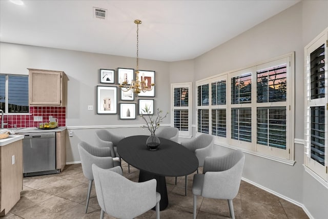 dining space with light tile patterned floors, a notable chandelier, and visible vents