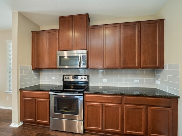 705 Estes Park, Taylor, TX 76574 - kitchen featuring stainless steel appliances, dark stone countertops, backsplash, and dark wood-style floors