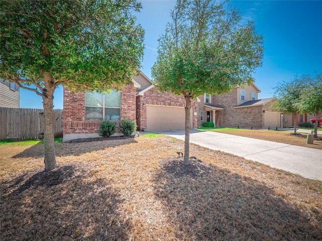 705 Estes Park, Taylor, TX 76574 - obstructed view of property featuring concrete driveway, a garage, and brick siding