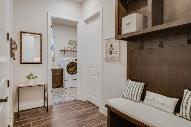 mudroom with dark wood-style flooring, washer / dryer, and baseboards