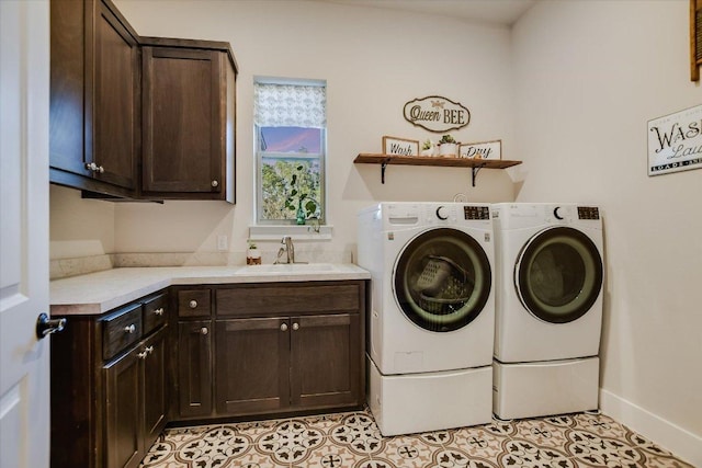 laundry room with independent washer and dryer, light tile patterned floors, cabinet space, a sink, and baseboards