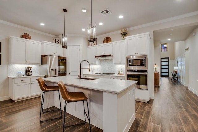 kitchen featuring a sink, visible vents, appliances with stainless steel finishes, and white cabinetry