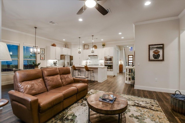 living room featuring recessed lighting, baseboards, dark wood finished floors, and ceiling fan with notable chandelier