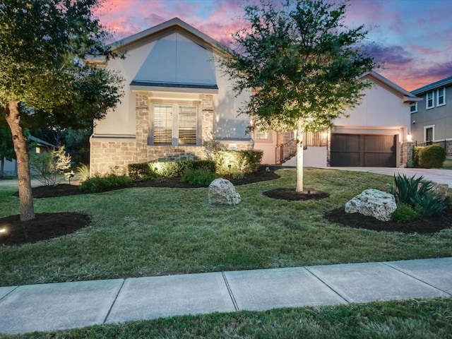 2512 Ionian Cv, Austin, TX 78730 - obstructed view of property with stucco siding, a yard, stone siding, and concrete driveway