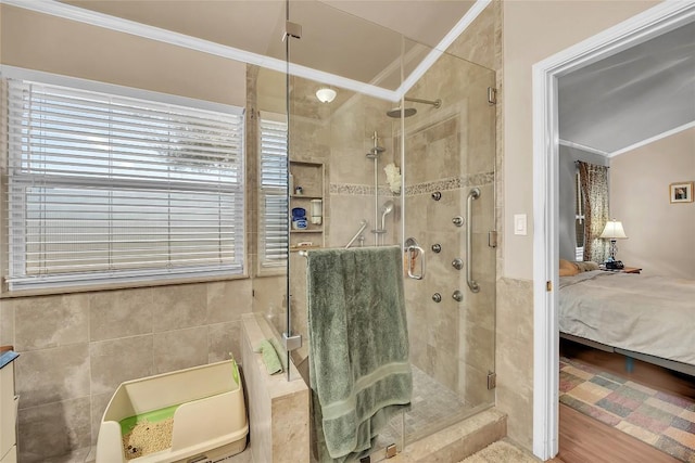 3607 Winding Way, Round Rock, TX 78664 - ensuite bathroom featuring a stall shower, crown molding, and tile walls