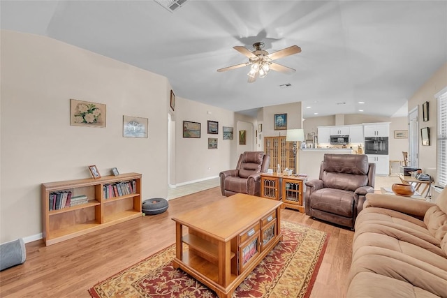 3607 Winding Way, Round Rock, TX 78664 - living area featuring lofted ceiling, light wood-style floors, ceiling fan, baseboards, and recessed lighting