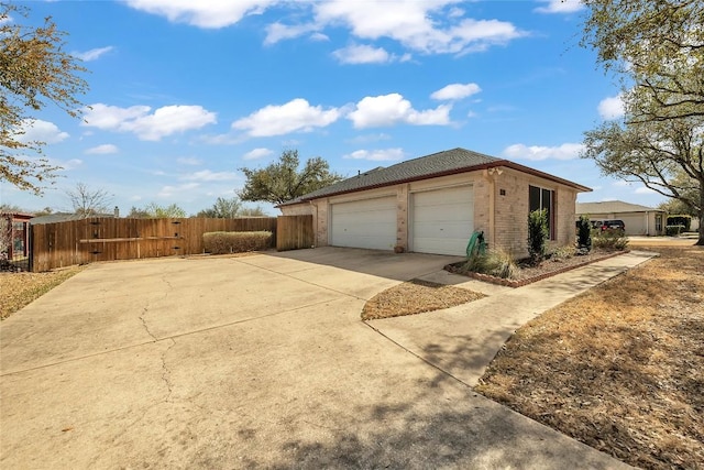 3607 Winding Way, Round Rock, TX 78664 - view of side of property with a garage, brick siding, and driveway