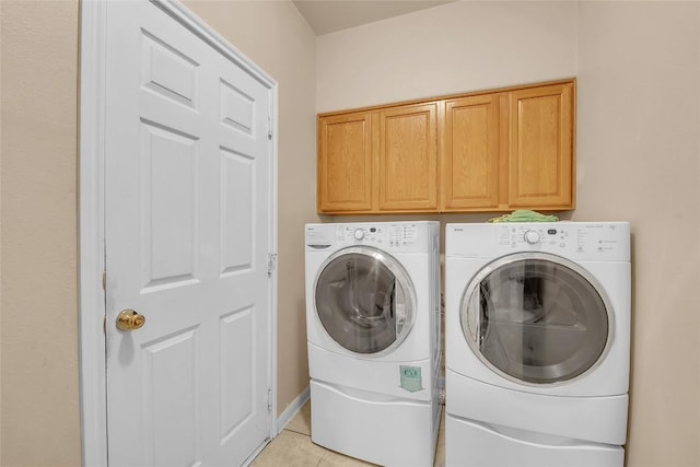 3607 Winding Way, Round Rock, TX 78664 - washroom with cabinet space, washing machine and clothes dryer, and light tile patterned floors