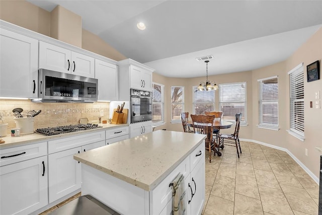 3607 Winding Way, Round Rock, TX 78664 - kitchen with stainless steel microwave, wall oven, decorative backsplash, a chandelier, and black gas cooktop