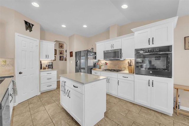 3607 Winding Way, Round Rock, TX 78664 - kitchen featuring appliances with stainless steel finishes, decorative backsplash, white cabinetry, light countertops, and a kitchen island