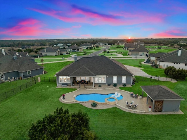 view of pool with a residential view, a patio, a fenced backyard, and a lawn