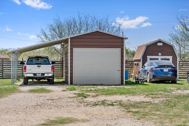 130 Holbox Dr, Del Valle, TX 78617 - garage featuring a garage and dirt driveway