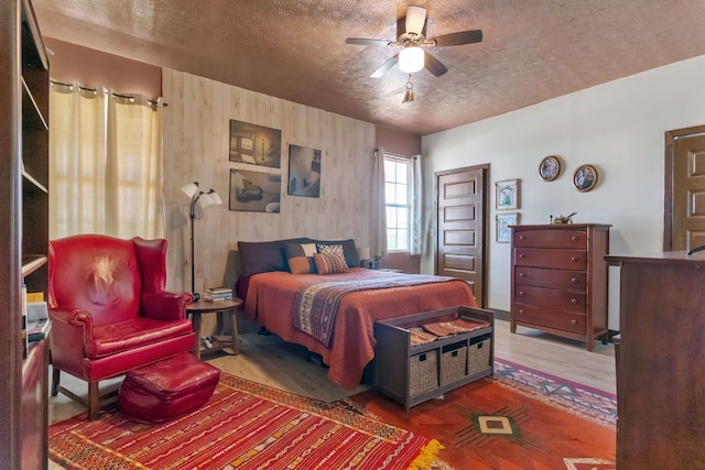 130 Holbox Dr, Del Valle, TX 78617 - bedroom featuring a textured ceiling, wood finished floors, and a ceiling fan