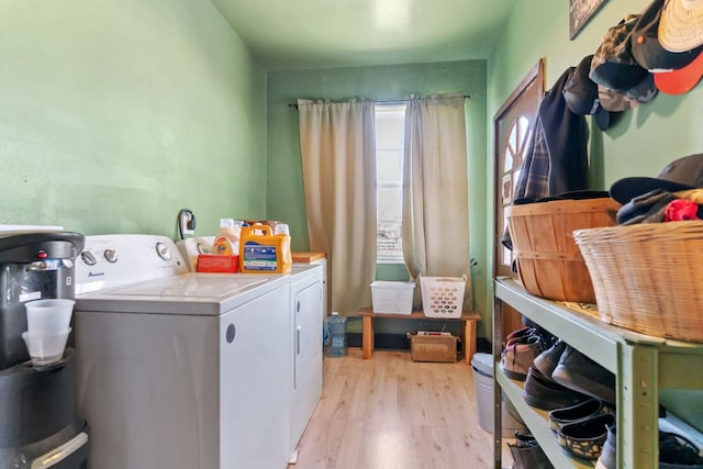 130 Holbox Dr, Del Valle, TX 78617 - laundry area featuring washing machine and dryer, light wood-type flooring, and water heater