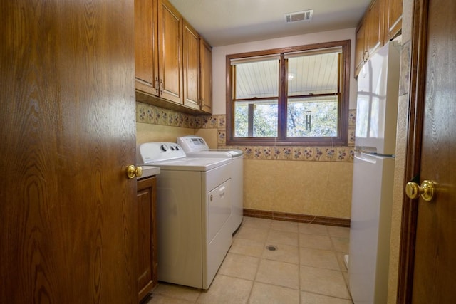 22207 Moulin Dr, Spicewood, TX 78669 - washroom featuring visible vents, cabinet space, baseboards, wallpapered walls, and washer and clothes dryer