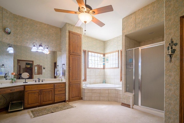 22207 Moulin Dr, Spicewood, TX 78669 - bathroom with vanity, ceiling fan, a garden tub, and a stall shower