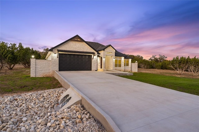 122 Liberty Bell Ln, Fischer, TX 78623 - french provincial home with an attached garage, concrete driveway, stone siding, and a front lawn