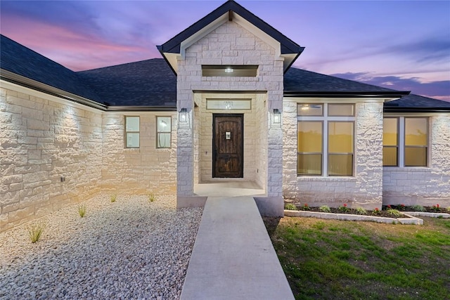 122 Liberty Bell Ln, Fischer, TX 78623 - view of exterior entry with stone siding and roof with shingles