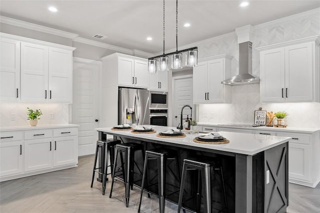 122 Liberty Bell Ln, Fischer, TX 78623 - kitchen with appliances with stainless steel finishes, wall chimney range hood, a breakfast bar area, ornamental molding, and light countertops