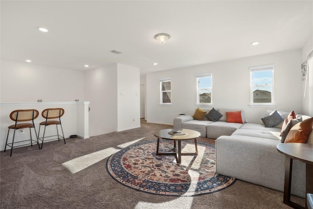 carpeted living area with recessed lighting and visible vents