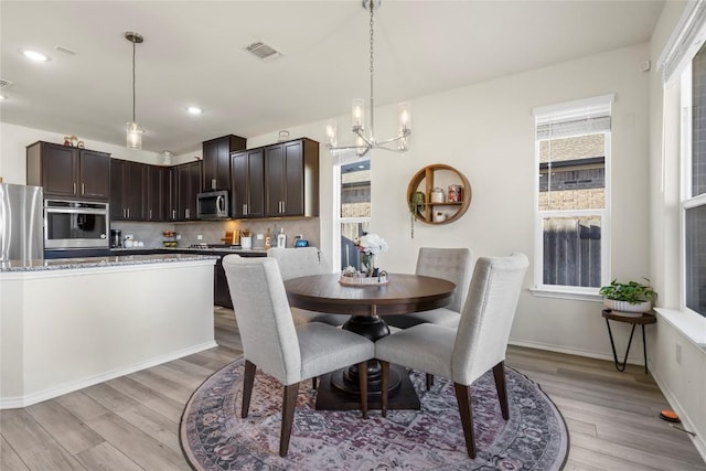 dining space with visible vents, plenty of natural light, and light wood-style flooring