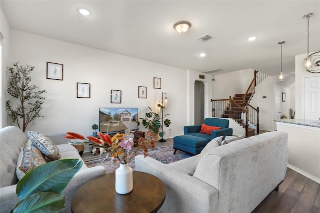 1128 Hemlen Cv, Leander, TX 78641 - living room with arched walkways, dark wood-type flooring, stairway, and recessed lighting