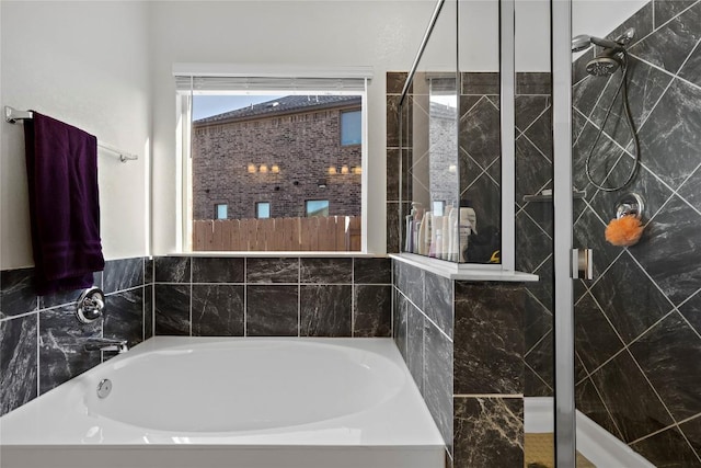 bathroom featuring tiled shower and a garden tub
