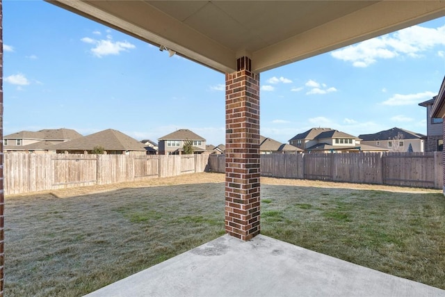 view of yard with a patio area, a residential view, and a fenced backyard
