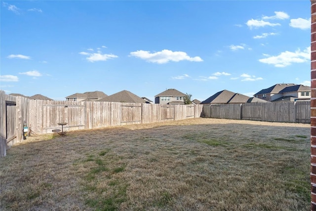 view of yard with a residential view and a fenced backyard