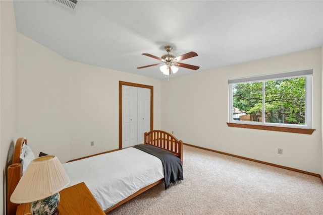 bedroom with visible vents, baseboards, a closet, a ceiling fan, and carpet