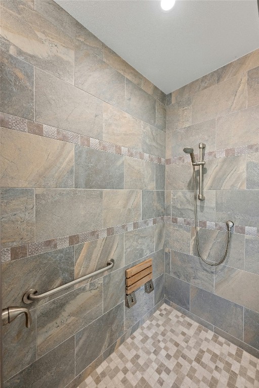 bathroom with tiled shower
