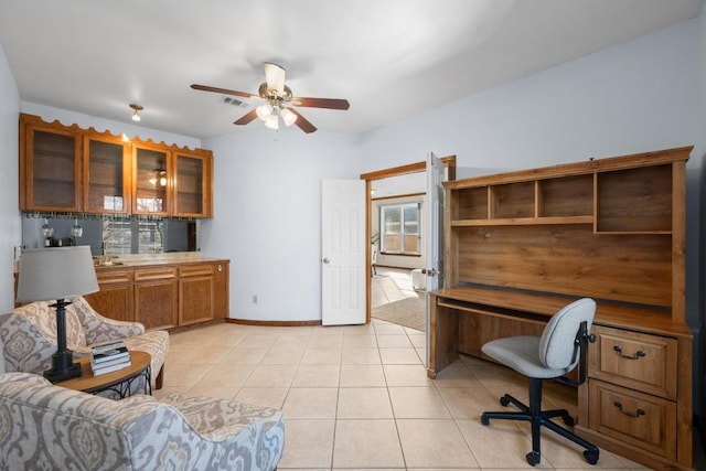 office area with visible vents, ceiling fan, light tile patterned flooring, and baseboards