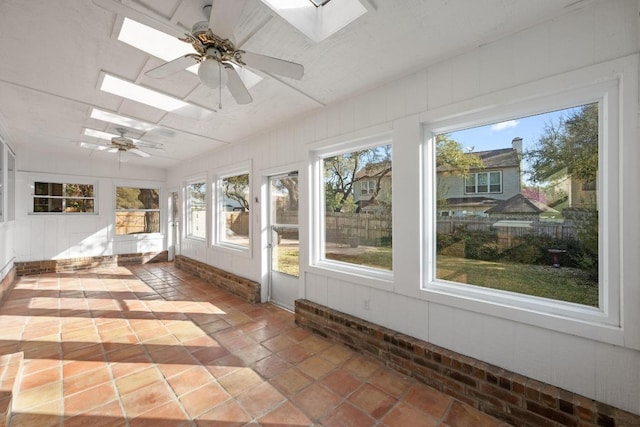 unfurnished sunroom with a skylight