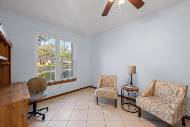 interior space with baseboards and a ceiling fan