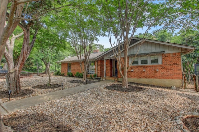 12333 Blue Water Dr, Austin, TX 78758 - view of front of house featuring brick siding and a chimney