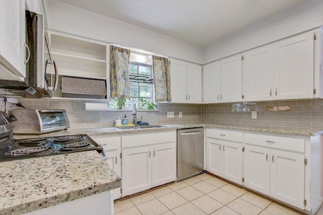 12333 Blue Water Dr, Austin, TX 78758 - kitchen with appliances with stainless steel finishes, a sink, light tile patterned flooring, white cabinetry, and decorative backsplash