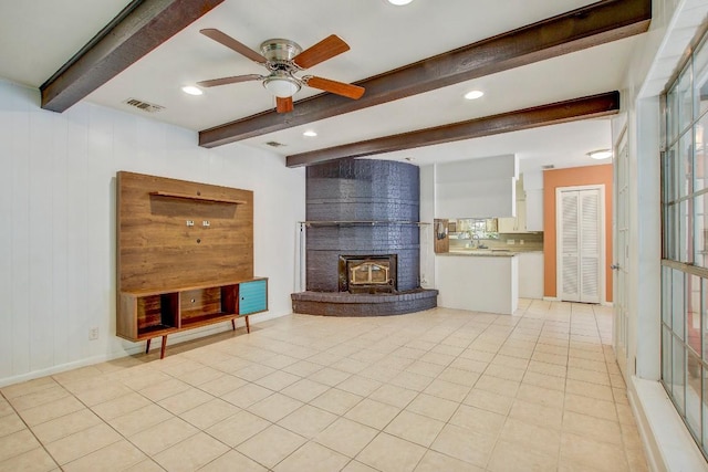 12333 Blue Water Dr, Austin, TX 78758 - unfurnished living room with beamed ceiling, ceiling fan, recessed lighting, and light tile patterned floors