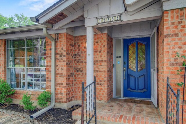 12333 Blue Water Dr, Austin, TX 78758 - doorway to property featuring brick siding
